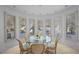 Charming breakfast nook with lots of windows, tile floors, and a round table perfect for dining at 10 Innisbrook Ave, Las Vegas, NV 89113