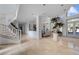 Spacious foyer with a curved staircase, chandelier lighting, and decorative greenery at 10 Innisbrook Ave, Las Vegas, NV 89113