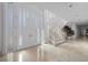 Bright foyer with curved staircase, tiled floors, and a modern door design at 10 Innisbrook Ave, Las Vegas, NV 89113