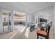 Bright home gym equipped with exercise machines, mirrored wall, and natural light from adjoining sunroom at 10 Innisbrook Ave, Las Vegas, NV 89113