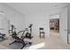 Home gym with stationary bikes, mirrored wall, and open doorway leading to other rooms at 10 Innisbrook Ave, Las Vegas, NV 89113