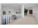 Upstairs hallway with plants, high ceilings and an overlook of the pool below at 10 Innisbrook Ave, Las Vegas, NV 89113