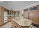 Bright kitchen with a center island, stainless steel appliances, marble countertops, and custom wood cabinets at 10 Innisbrook Ave, Las Vegas, NV 89113