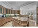 Bright kitchen with a center island, stainless steel appliances, marble countertops, and custom wood cabinets at 10 Innisbrook Ave, Las Vegas, NV 89113