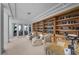 Well-lit library featuring custom bookshelves, a desk, and comfortable seating with a view to the exterior at 10 Innisbrook Ave, Las Vegas, NV 89113