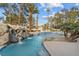 Backyard swimming pool with a rock waterfall feature and clear blue water, creating a serene outdoor escape at 10 Innisbrook Ave, Las Vegas, NV 89113