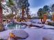 Resort-style pool with waterfall, spa, and lush landscaping creating a private oasis at 10 Innisbrook Ave, Las Vegas, NV 89113