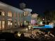 Luxurious backyard with pool, rock waterfall feature, and exterior lighting for evening ambiance at 10 Innisbrook Ave, Las Vegas, NV 89113