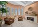 Sitting area with fireplace, ample lighting, and plantation shutters throughout at 10 Innisbrook Ave, Las Vegas, NV 89113