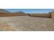 Large, level backyard with a retaining wall, offering ample space for customization and landscaping at 10239 Meandering Dell Ave, Las Vegas, NV 89166