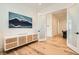 Bonus room with hardwood floors featuring white media cabinet and glass paneled door at 10239 Meandering Dell Ave, Las Vegas, NV 89166