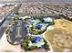 Aerial view of community center with pool, clubhouse, splash pad, park, playground, and parking lot at 10239 Meandering Dell Ave, Las Vegas, NV 89166