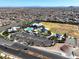 Wide aerial view of a community center, amenities, parking and adjacent homes in a Primary-planned community at 10239 Meandering Dell Ave, Las Vegas, NV 89166