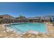 Community pool with lounge chairs, umbrellas, and a pool house, creating a relaxing environment at 10239 Meandering Dell Ave, Las Vegas, NV 89166