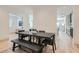 Contemporary dining room features hardwood floors, a stylish black table, and seamless access to other living spaces at 10239 Meandering Dell Ave, Las Vegas, NV 89166