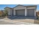 Charming one-story home boasting a three-car garage, stone accents, and a neatly landscaped front yard at 10239 Meandering Dell Ave, Las Vegas, NV 89166