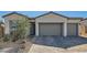Charming one-story home boasting a three-car garage, stone accents, and a neatly landscaped front yard at 10239 Meandering Dell Ave, Las Vegas, NV 89166