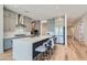 Spacious kitchen featuring an island with bar seating, stainless steel appliances, and stylish gray cabinetry at 10239 Meandering Dell Ave, Las Vegas, NV 89166
