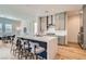 Bright kitchen features an island with bar seating, stainless steel appliances, and light gray cabinetry at 10239 Meandering Dell Ave, Las Vegas, NV 89166