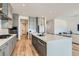 Spacious kitchen features a large island, stainless steel appliances, and elegant gray cabinetry at 10239 Meandering Dell Ave, Las Vegas, NV 89166