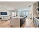 Bright, open-concept living room with a modern kitchen island and hardwood floors at 10239 Meandering Dell Ave, Las Vegas, NV 89166