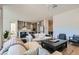 Bright living room flows into the kitchen, featuring hardwood floors, comfortable seating, and modern décor at 10239 Meandering Dell Ave, Las Vegas, NV 89166