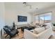 Bright living room offering hardwood floors, comfortable seating, modern décor, and lots of natural light at 10239 Meandering Dell Ave, Las Vegas, NV 89166