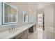 Bright main bathroom with dual sinks, sleek vanity, and soaking tub at 10239 Meandering Dell Ave, Las Vegas, NV 89166