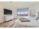 Spacious main bedroom featuring hardwood floors, backyard access and white accents at 10239 Meandering Dell Ave, Las Vegas, NV 89166