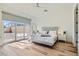 Bright primary bedroom with hardwood floors and glass sliding doors to backyard at 10239 Meandering Dell Ave, Las Vegas, NV 89166