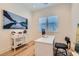 Bright office space with a modern desk, comfortable chair, and a mountain landscape art piece at 10239 Meandering Dell Ave, Las Vegas, NV 89166