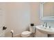 Modern powder room featuring contemporary pedestal sink, black accents and LED mirror at 10239 Meandering Dell Ave, Las Vegas, NV 89166