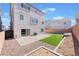 Spacious backyard with turf, zero-scaping, concrete patio, and privacy wall at 10319 Santero Bay Ct, Las Vegas, NV 89141