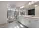Modern bathroom featuring a double vanity, walk-in shower, and modern tile flooring at 10319 Santero Bay Ct, Las Vegas, NV 89141