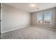 Carpeted bedroom with neutral paint, windows, and contrasting doors at 10319 Santero Bay Ct, Las Vegas, NV 89141