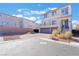 Inviting two-story home featuring a two-car garage, balcony and manicured landscaping at 10319 Santero Bay Ct, Las Vegas, NV 89141