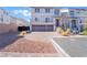 Inviting two-story home featuring a two-car garage, landscaped front yard, and paved driveway at 10319 Santero Bay Ct, Las Vegas, NV 89141