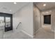 Bright hallway featuring neutral paint, carpet, and a railing leading to the stairs at 10319 Santero Bay Ct, Las Vegas, NV 89141