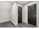 Hallway with wood floors and two black doors, providing ample storage and access to various areas at 10319 Santero Bay Ct, Las Vegas, NV 89141