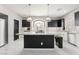 Modern kitchen features black cabinets, white countertops and backsplash, and central island at 10319 Santero Bay Ct, Las Vegas, NV 89141