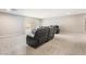 Finished basement featuring a large sectional sofa and plush neutral carpet at 10319 Santero Bay Ct, Las Vegas, NV 89141