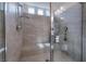 Modern shower featuring glass doors, tiled walls and a shower head at 10319 Santero Bay Ct, Las Vegas, NV 89141