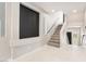 Bright staircase with carpeted steps, white marble floors, and neutral paint colors at 10319 Santero Bay Ct, Las Vegas, NV 89141