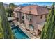 Aerial view showcasing property with private pool, spa, lounge area, and manicured greenery at 10671 Capesthorne Way, Las Vegas, NV 89135