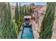 Aerial view of luxury home with a private pool, outdoor kitchen, spa, and privacy landscaping at 10671 Capesthorne Way, Las Vegas, NV 89135