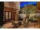Cozy brick-paved patio features outdoor seating and a stylish fire pit at 10671 Capesthorne Way, Las Vegas, NV 89135