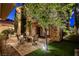 Back patio with stone accents provides space for outdoor seating and entertaining at 10671 Capesthorne Way, Las Vegas, NV 89135