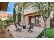 The outdoor area features a fire pit and chairs, perfect for enjoying the beautifully landscaped backyard at 10671 Capesthorne Way, Las Vegas, NV 89135