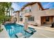 Beautiful backyard with a pool, jacuzzi, and outdoor seating areas perfect for entertaining at 10671 Capesthorne Way, Las Vegas, NV 89135