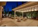 Outdoor patio features a covered seating area, fire pit, and tranquil water feature at 10671 Capesthorne Way, Las Vegas, NV 89135